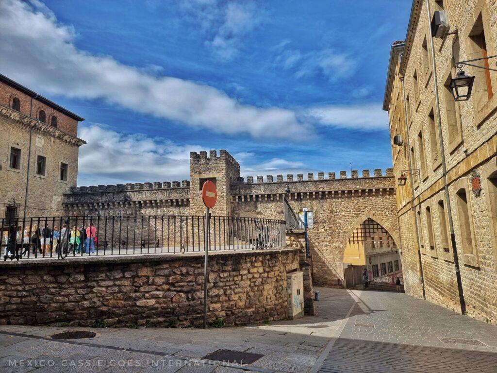 old city wall (restored) with gateway and raised plaza on left