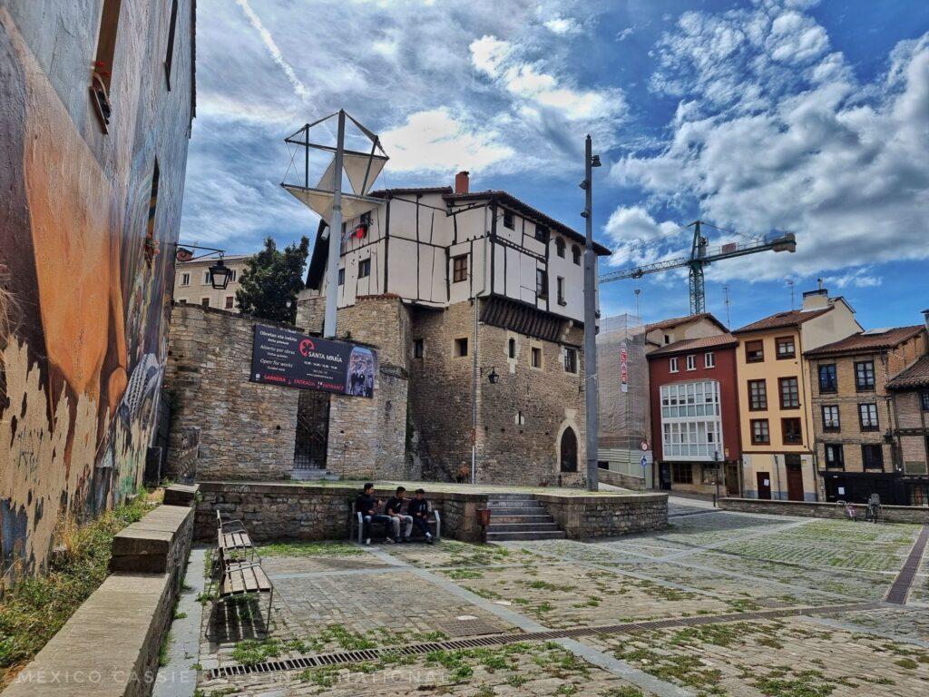 Plaza de la Burulleria - interesting old buildings around, grass growing from between cobbles