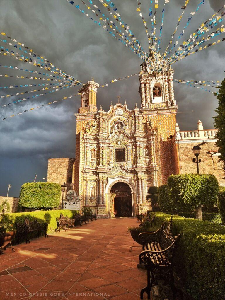 striking church against deep grey sky, bunting coming from top of church