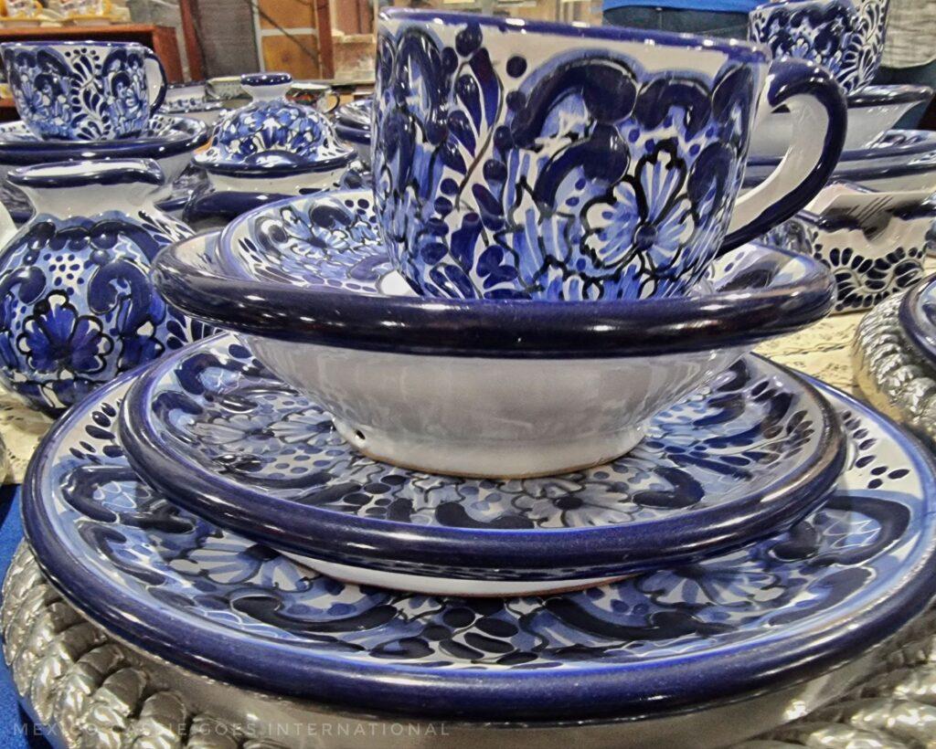 blue and white pottery plates and cup piled up