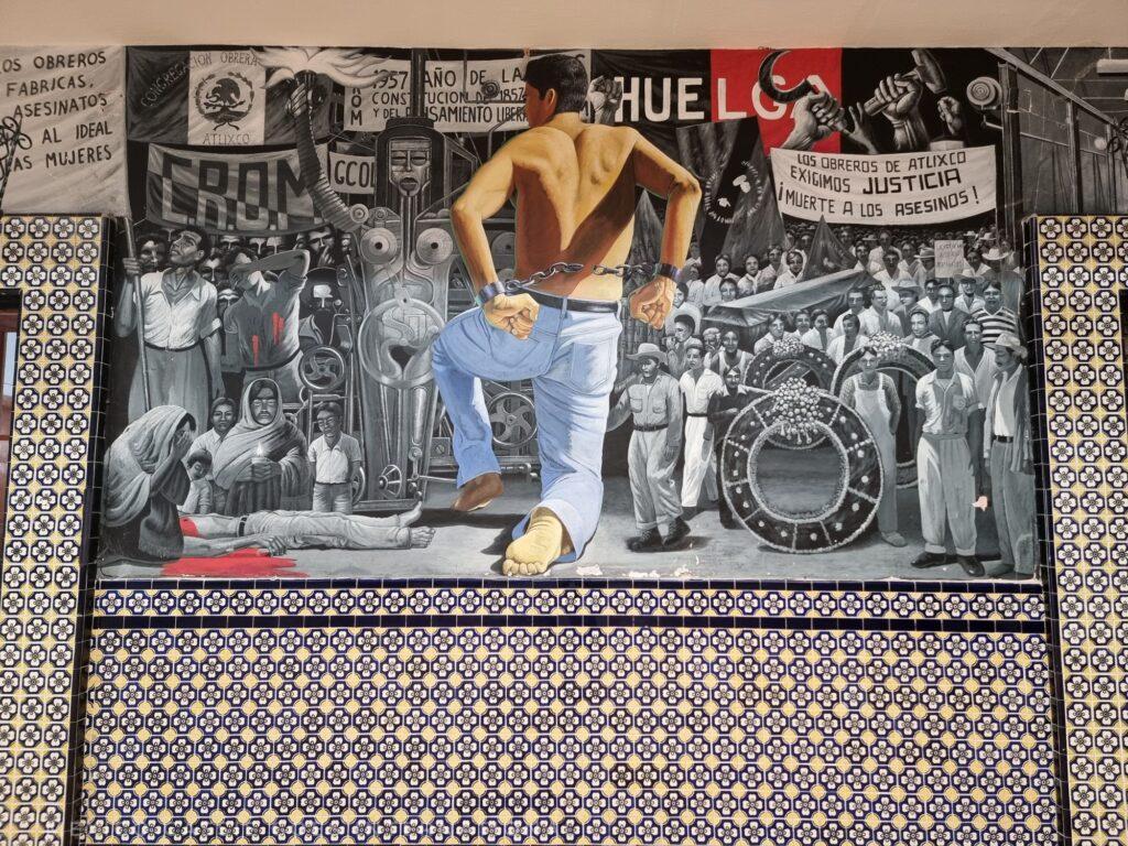mural to the workers who lost their lives due to bad conditions in factories - text (in spanish) demands justice and death to the assassins