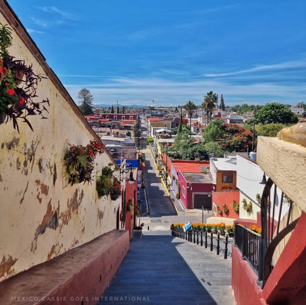 looking down a flight of steps across a city