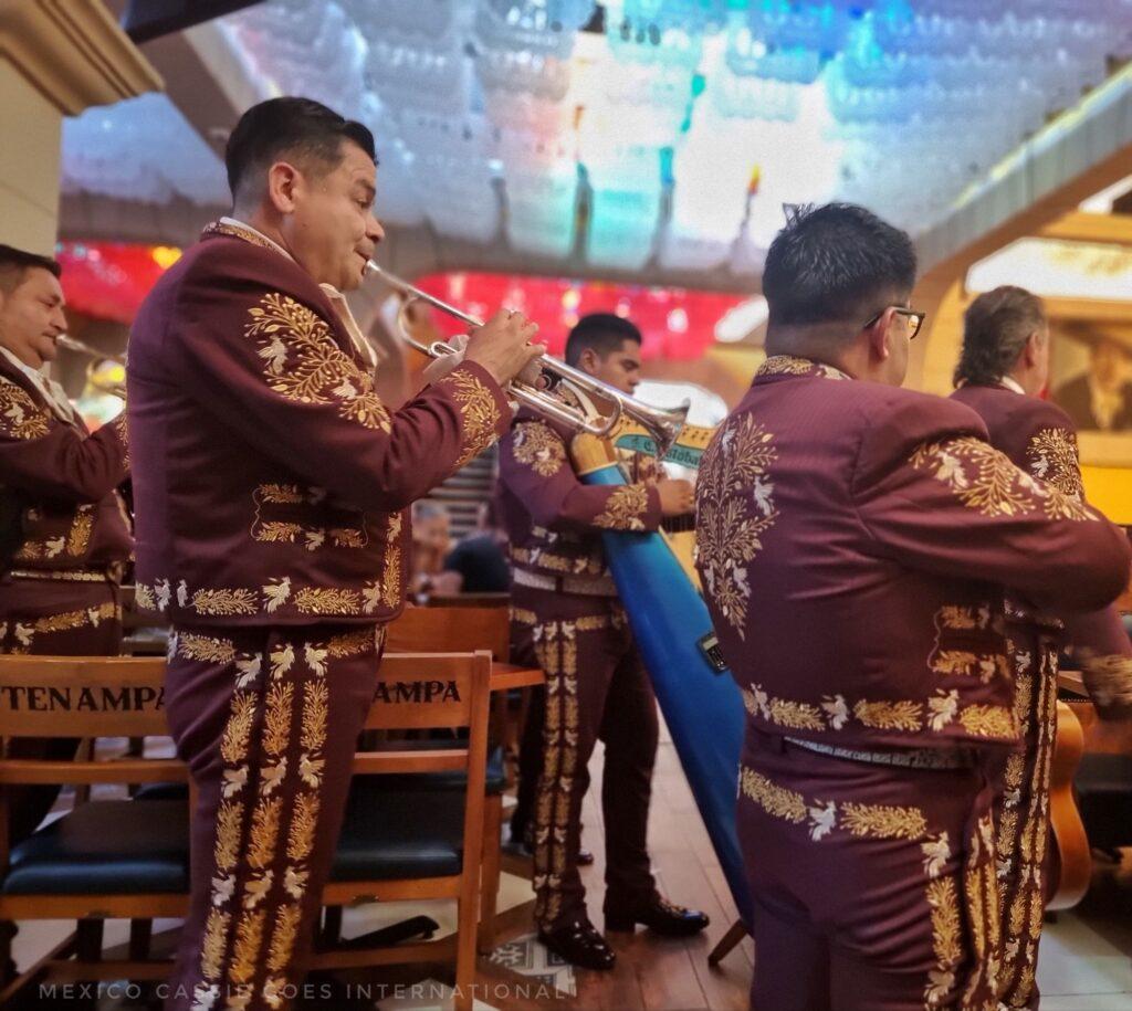 men in burgendy and gold suits playing brass instruments