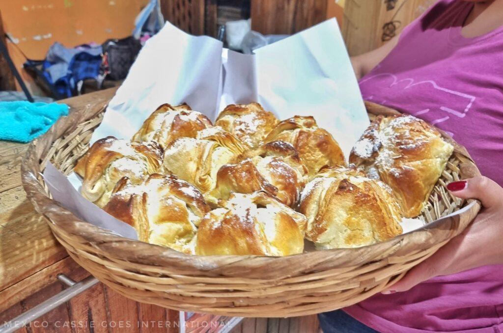 basket of pastries held in woman's hands