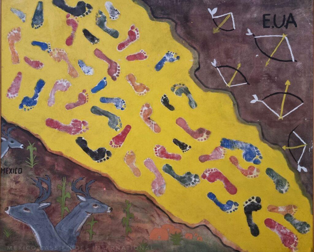 photo of a abstract painting of the border between Mexico and the USA. Yellow space with painted footprints splits the lands - bows and arrows on US side, deer on Mex side