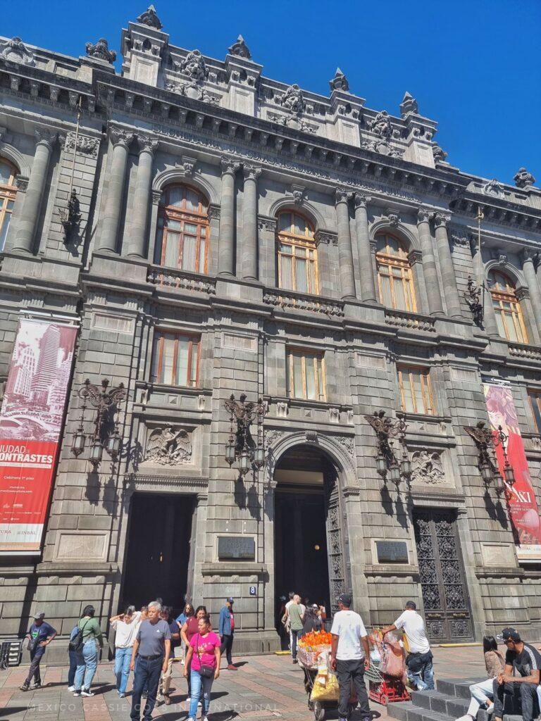view of the entrance to MUNAL museum in CDMX, people milling around outside