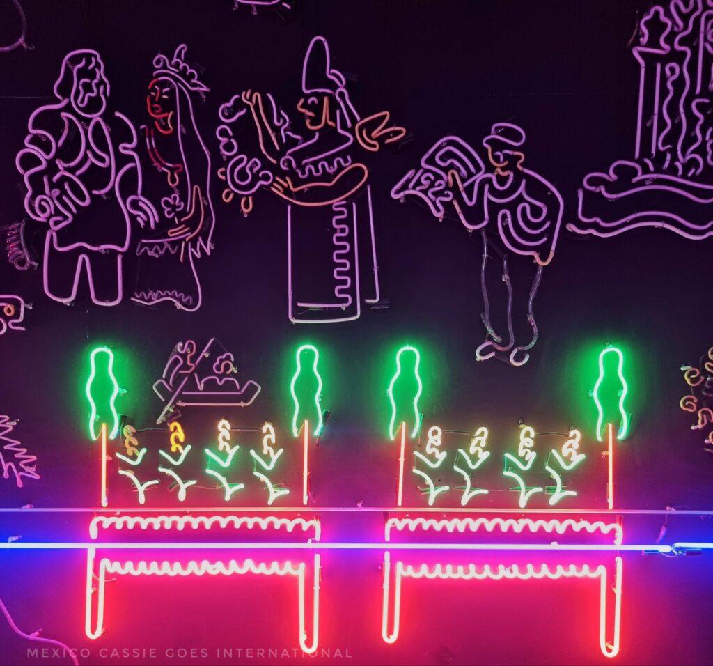 neon display (half lit) of the history of Mexico City