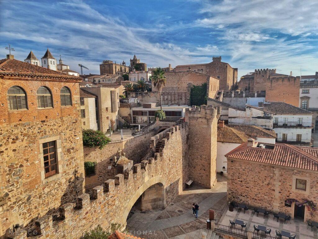 looking down on medieval city wall, buildings and plaza