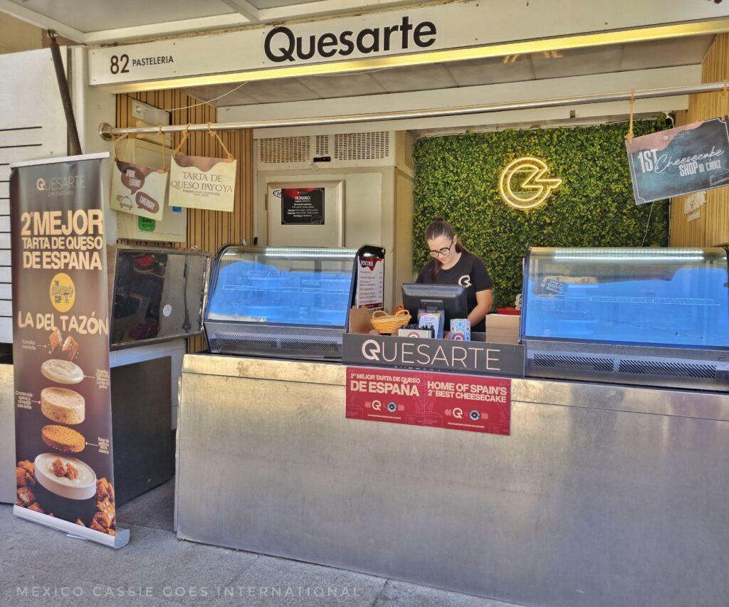 cheese cake stand in market with person selling visible