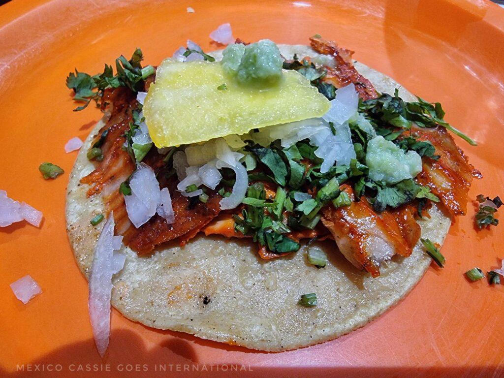 one taco - pasto meat, onion, cilantro, pineapple