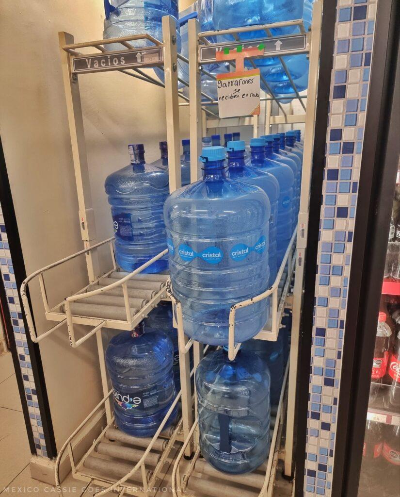 stacks of garafons (large blue 20l water bottles)