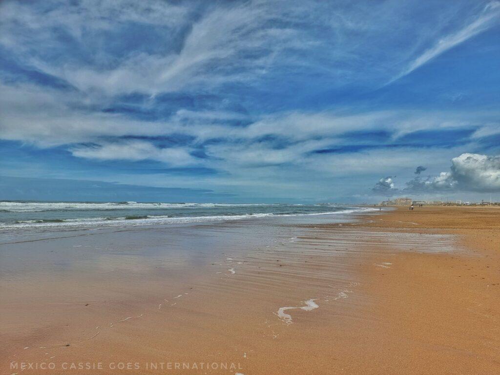 vast and empty beach, sand, blue sky