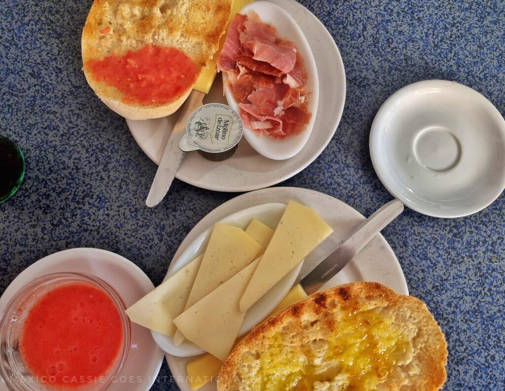 two plates with toast, one with cheese on plate, one with ham and tomato. separate bowl with liquid tomato