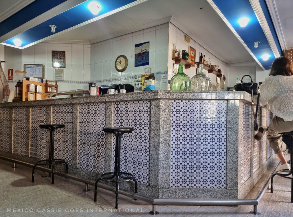 typical spanish bar, covered in tiles, bar stools 