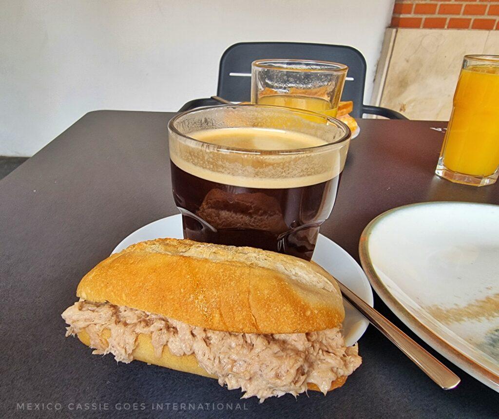 tuna roll and black coffee in a glass
