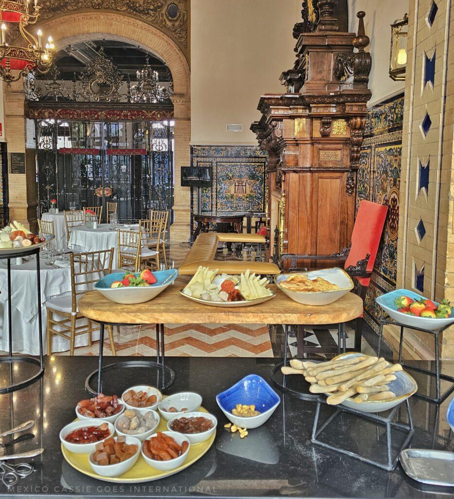 breakfast buffet, small bowls on trays, wooden chest in background