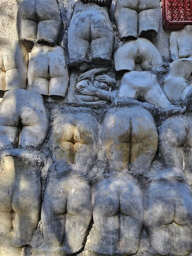 wall of sculpted bums