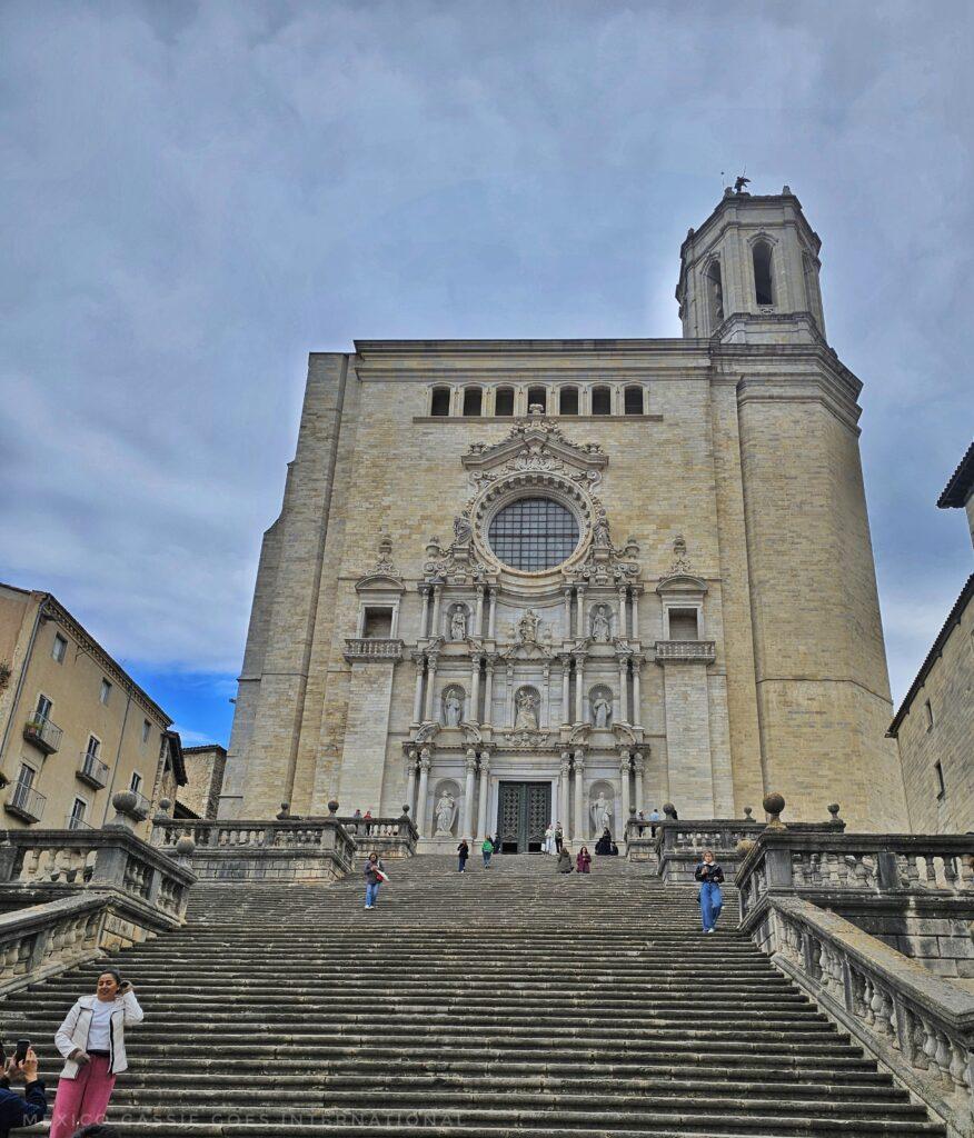 view up the extremely wide steps in front of the church. people on steps