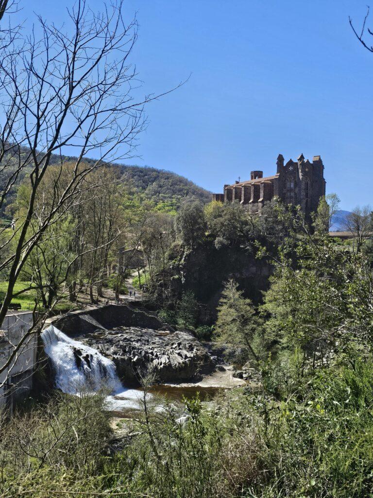 large church on hill, small waterfall in front