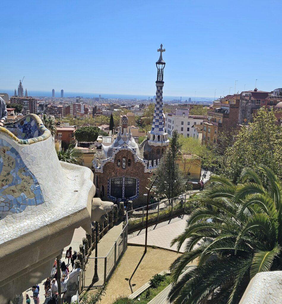 photo of Park Güell with the mosaic house in front, people milling around