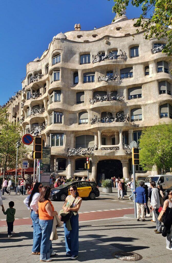 gaudi buildign in barcleona with people standing around in front