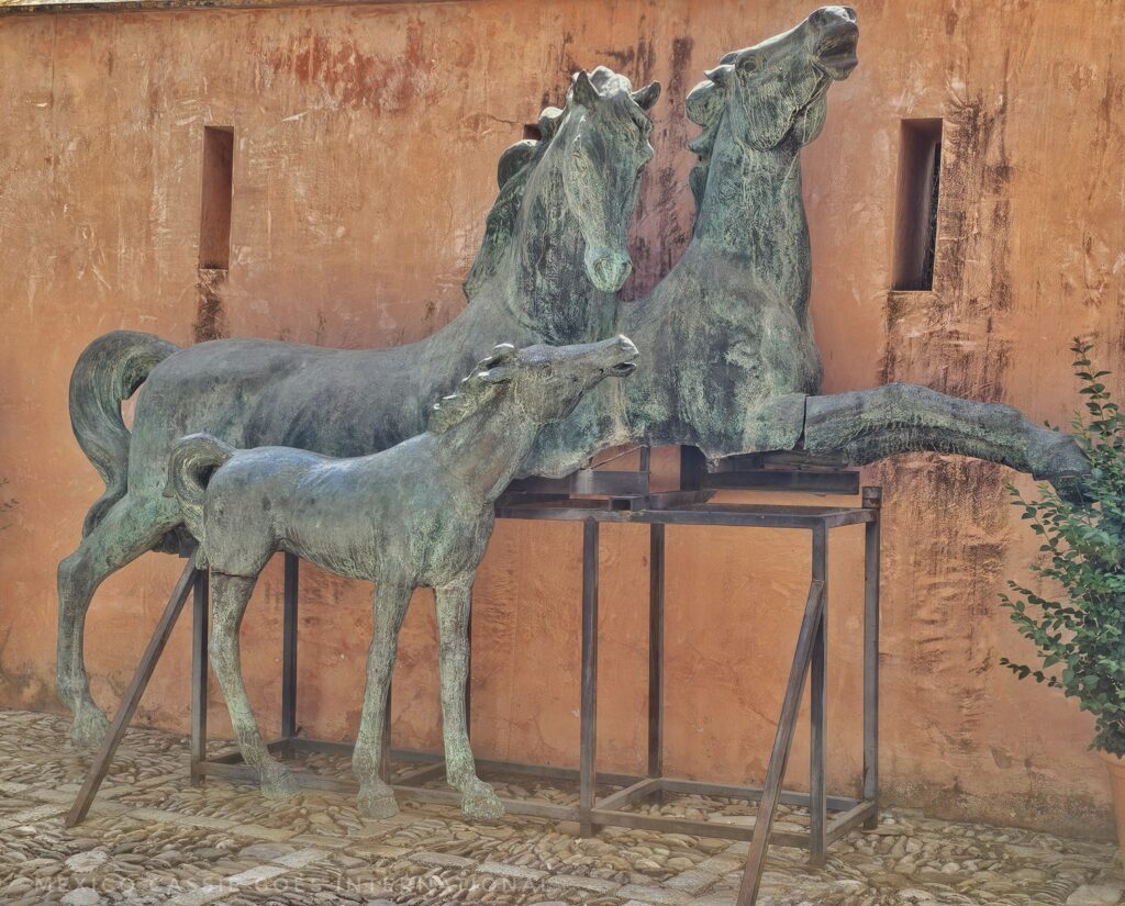 sculpture of two horses and a foal