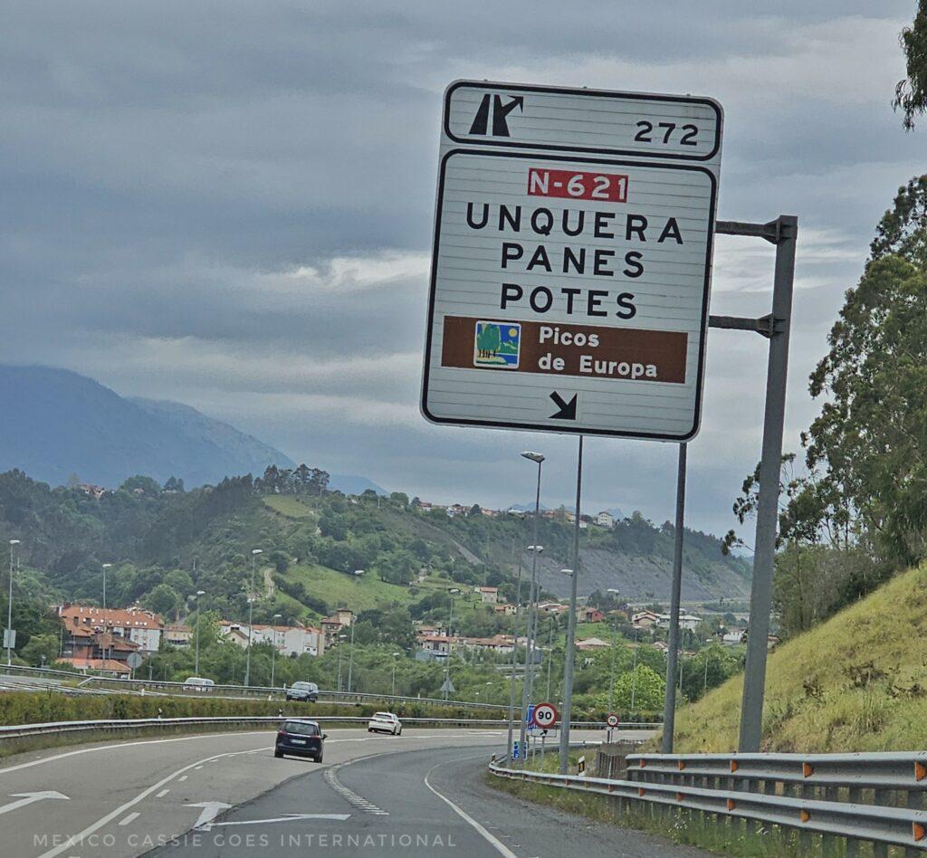 road sign that says 272, Unquera, Panes, Botes, Picos de Europea with arrow to right