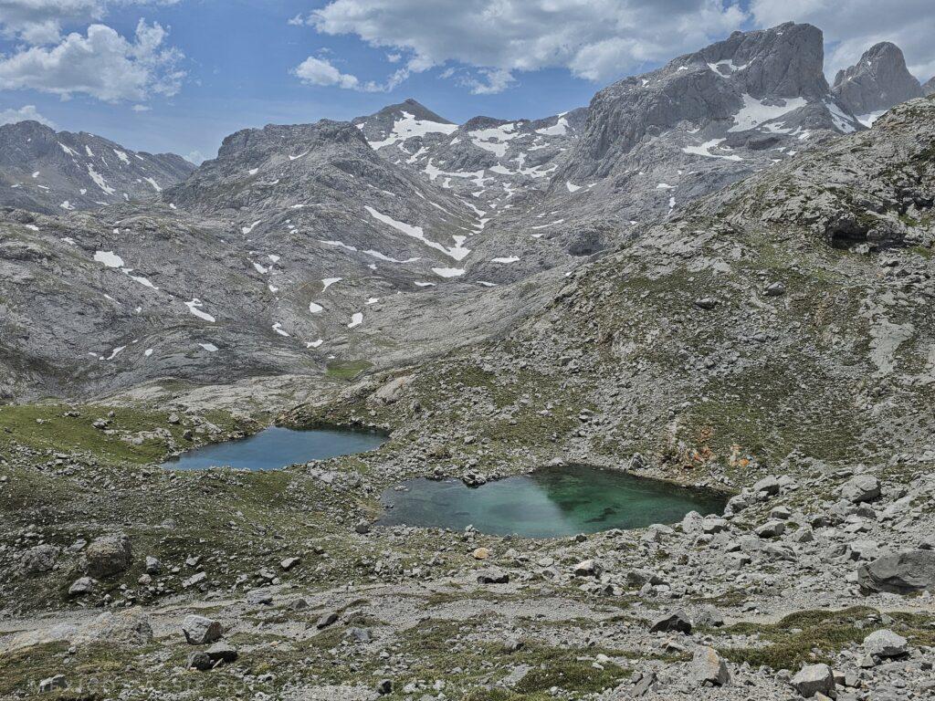 small mountain lake, mountains with snow all around