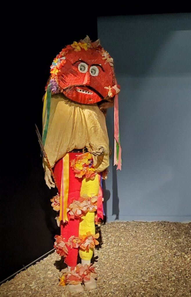 festival costume, red circular mask, shawl, red and yellow trousers