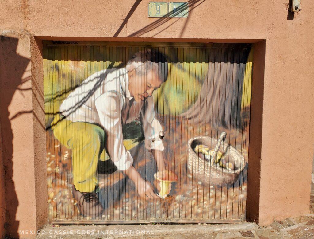 mural of a man in his garden, basket next to him