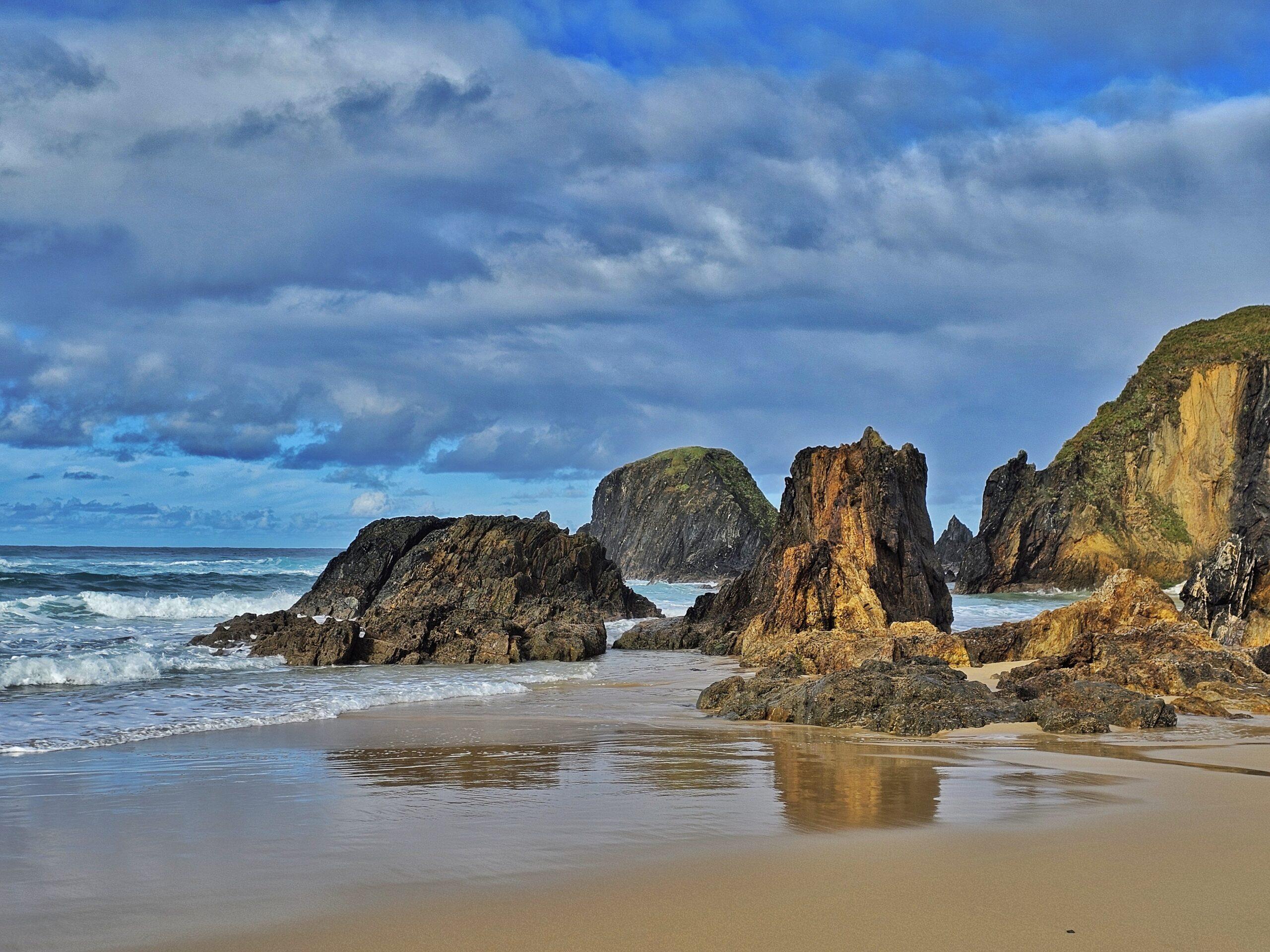 sandy beach with gorgeous rock formations in the water