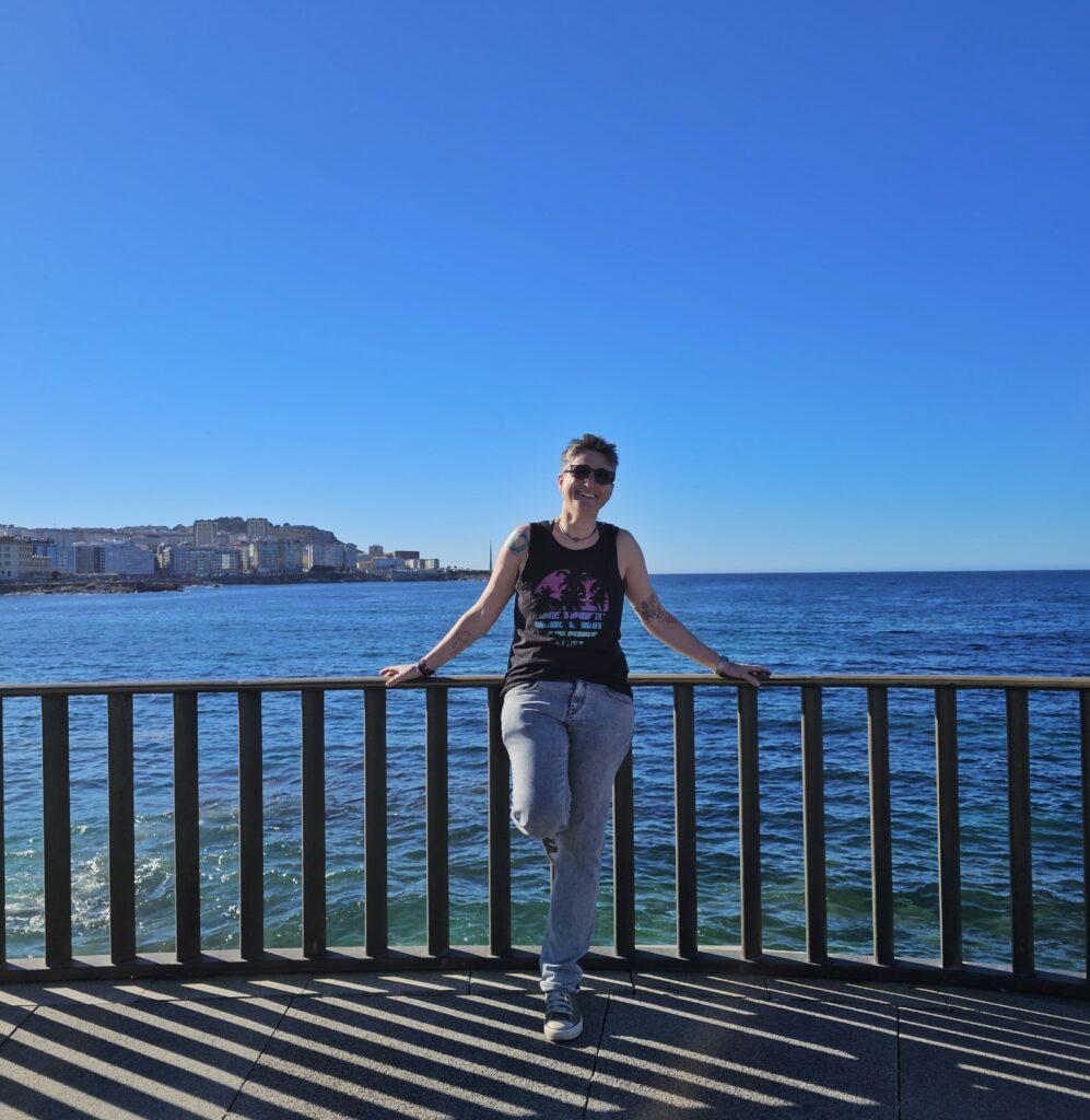 Cass in front of ocean at a look out, land behind to left over ocean