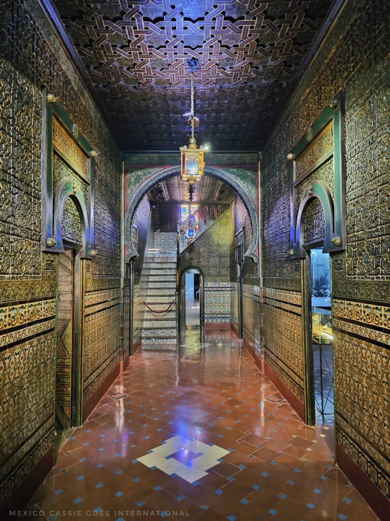 beautifully decorated andaluz hallway with rooms off to either side and stairs at end