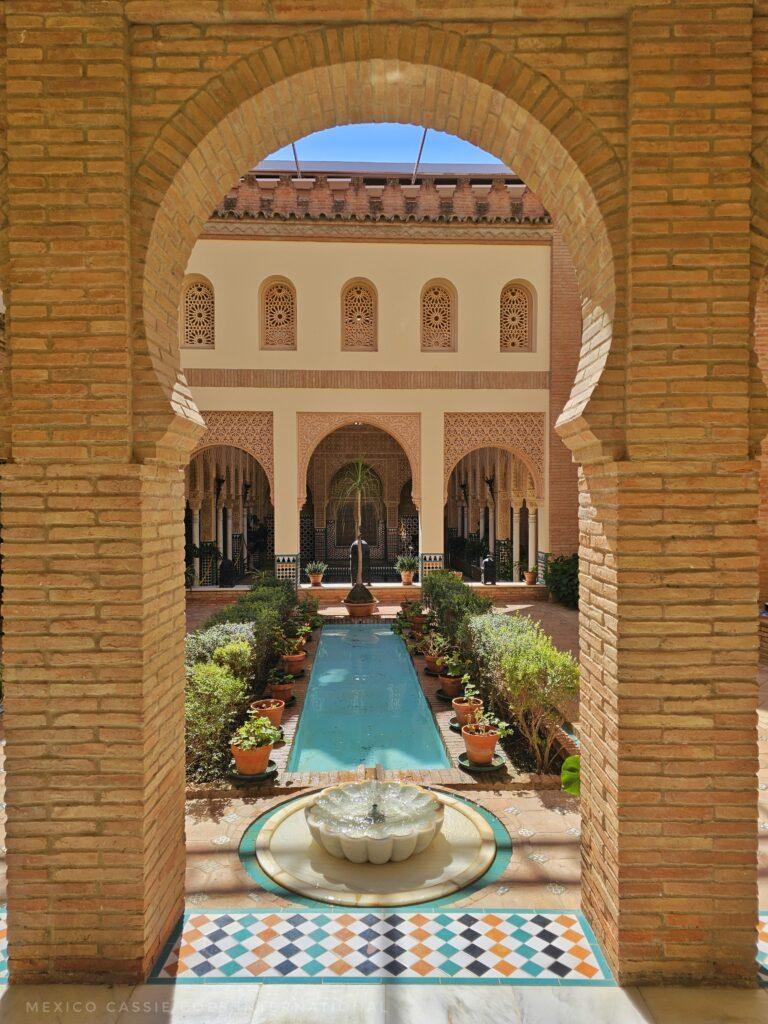 replica of the alhambra, water way through almohad arch, columns at end