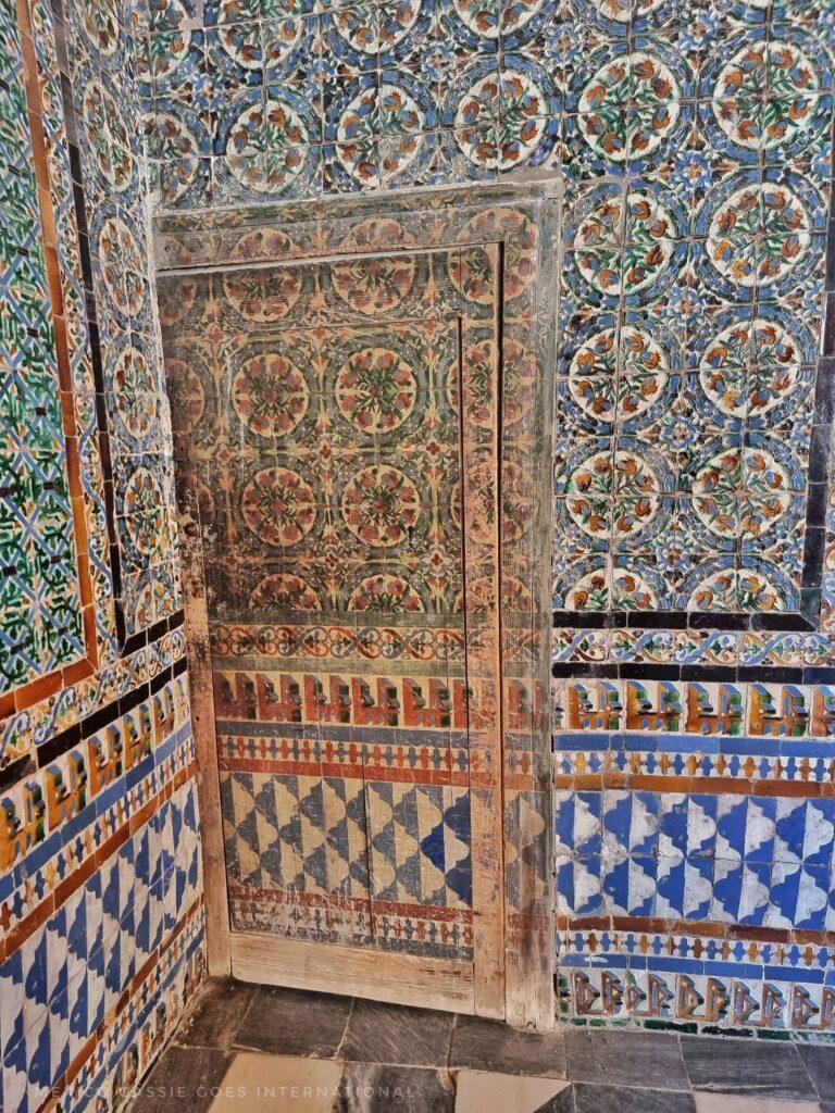hidden door in ornate tiles