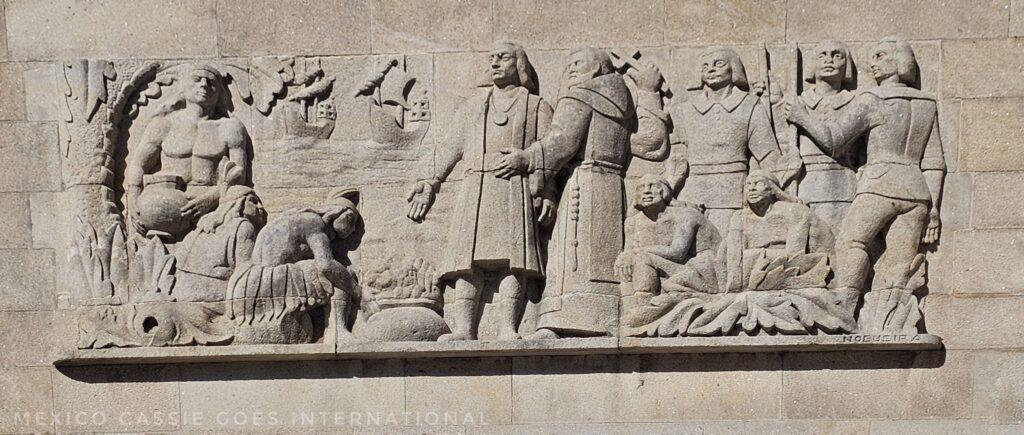 relief carving of Spanish people in the Americas treating Indigenous people badly (on the wall of the port building, an utter disgrace)
