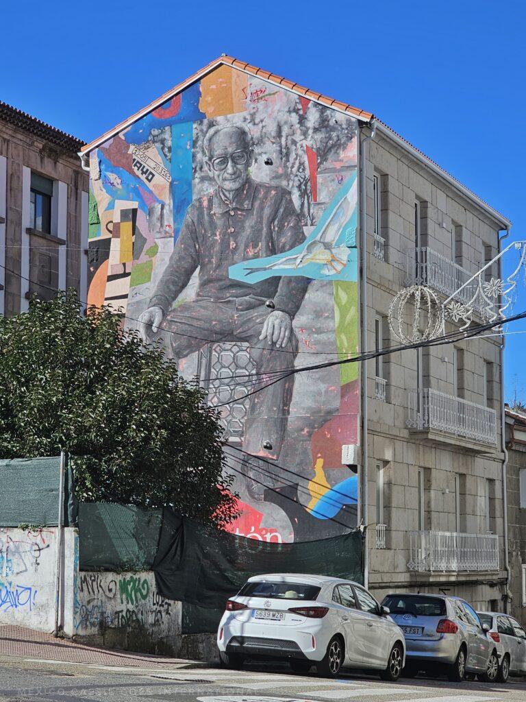 painting on the side of a house of a man
