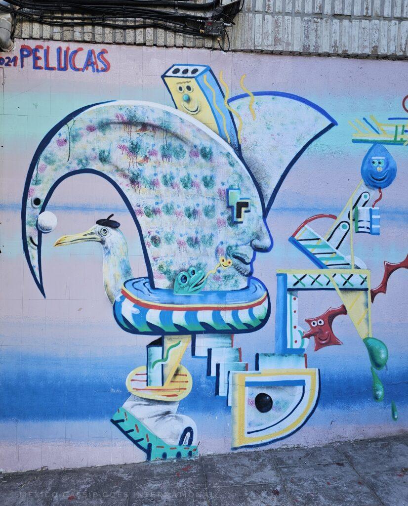 strange pastel street art of a face and with a frog, a pelican and more
