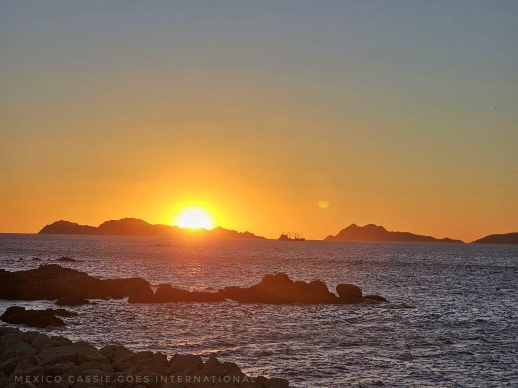 sunset over small islands out at sea