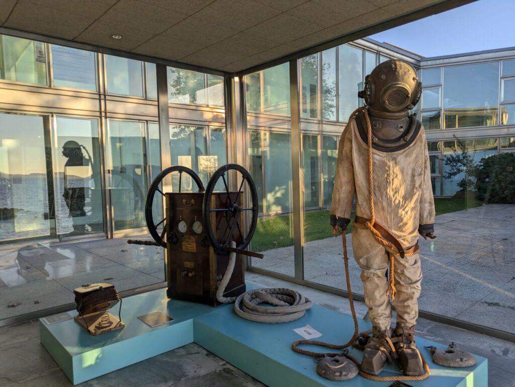 old diving suit on display by window