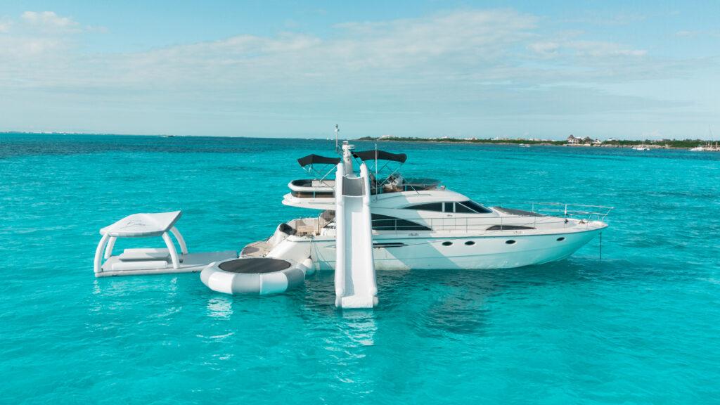 small yacht with slide and other fun equipment in perfect blue water